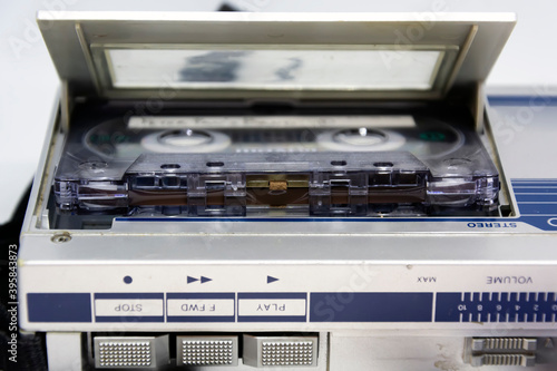Detail of the head behind the magnetic tape of an old audio cassette inserted in a player