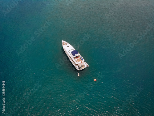 Drone shot of the beautiful white yacht in the warm blue sea  millionaire concept. © Semachkovsky 