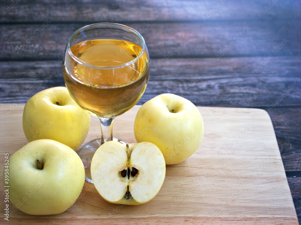 Apple juice and yellow apples fruit on wooden background Apple juice and yellow apples fruit on wooden background