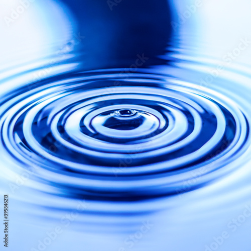 Circles on the water. Close-up top view of blue water rings.