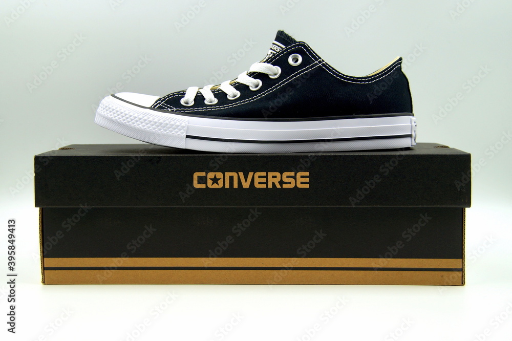 Amsterdam, Netherlands - January 16, 2018: Black Chuck Taylor Converse All Star low top standing on a retail box, against a white Stock Photo | Adobe Stock