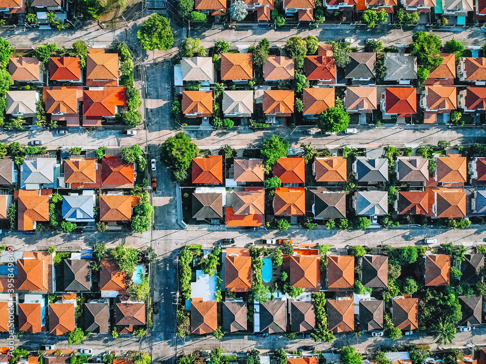 Aerial top view villages with orange roofs and gardens with nature green on the outskirts of the city Aerial top view villages with orange roofs and gardens with nature green on the outskirts of the city