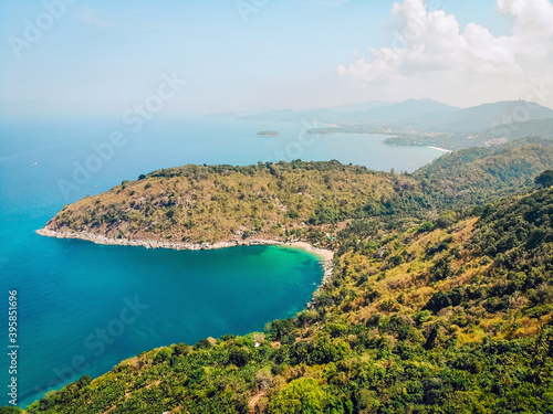 Top view or Aerial view of tropical island forest and emerald clear water of a magnificent coast photo