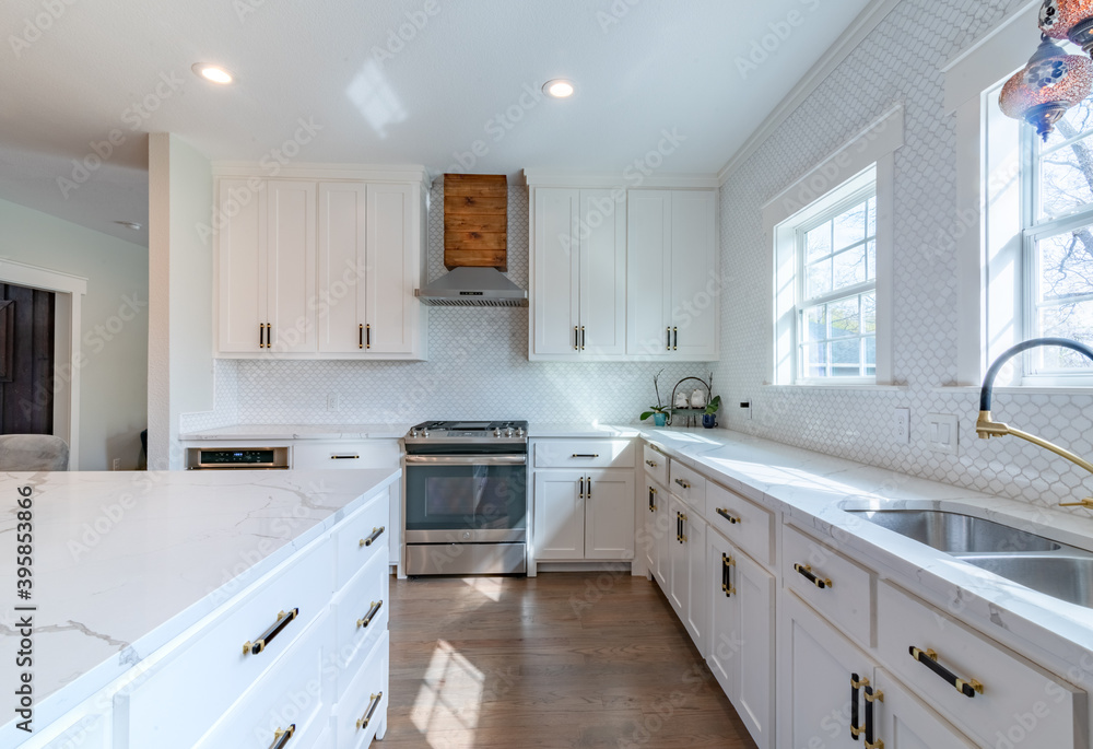 White quartz kitchen with cedar vent, windows, black and gold fixtures - obrazy, fototapety, plakaty 