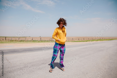 Portrait of romantic happy female with blowing hair enjoy weather and sunny day outside. Portrait of beautiful young woman smiling with windy hair on face. People, lifestyle