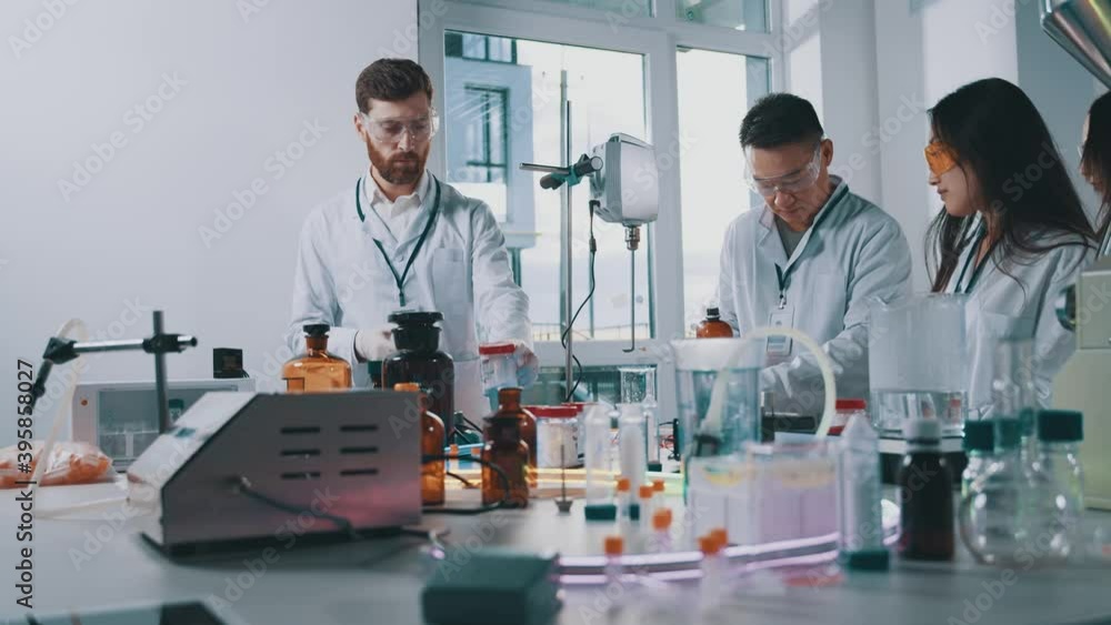 Laboratory concept. Healthcare team of workers conducting scientific experiments with chemical liquids in research facility modern lab cooperating. Laboratory concept. Healthcare team of workers conducting scientific experiments with chemical liquids in research facility modern lab cooperating.