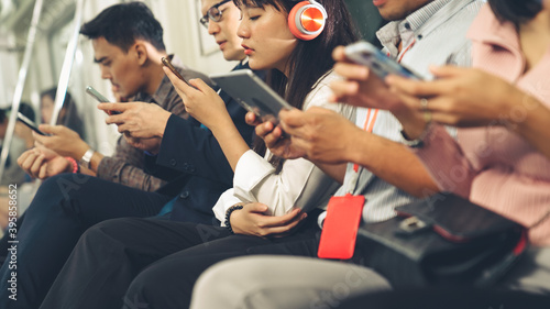 Photography Young people using mobile phone in public underground train