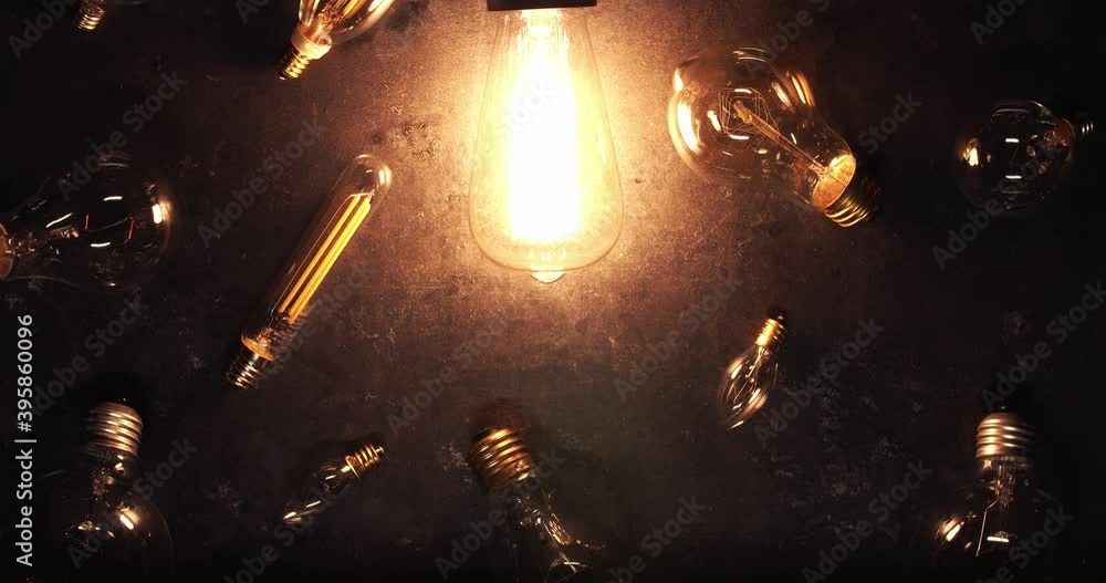Vintage incandescent light bulb flickering on surrounded by old burnt out bulbs. Fresh idea