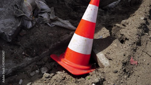 Wallpaper Mural A traffic cone warning of a hole in the road. Damaged road and traffic cone. Torontodigital.ca
