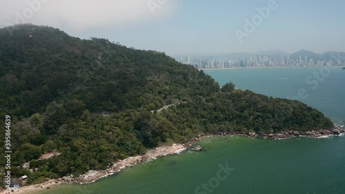 Vista aérea da Rodovia Interpraias em Balneário Camboriú, Santa Catarina. Aerial view de praia agreste com metrópole ao fundo.  photo