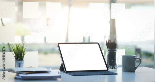 Wallpaper Mural Modern workspace with a tablet computer, pot plant, notebook and coffee cup on white desk. Blank screen monitor for graphic display montage. Torontodigital.ca