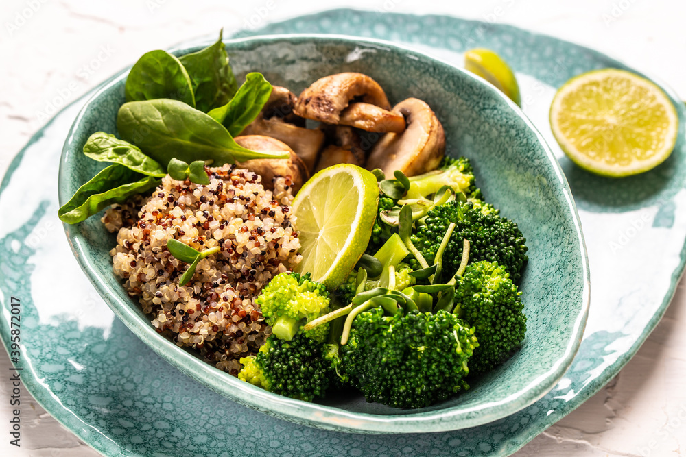 Green vegetable vegan salad with spinach, mushrooms and broccoli and quinoa. Healthy vegetarian food concept. top view Green vegetable vegan salad with spinach, mushrooms and broccoli and quinoa. Healthy vegetarian food concept. top view
