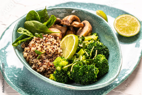 Green vegetable vegan salad with spinach, mushrooms and broccoli and quinoa. Healthy vegetarian food concept. top view