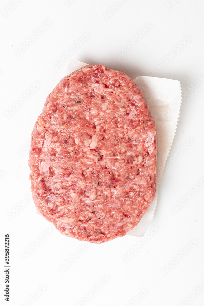 Raw minced homemade cutlets, on the white background Raw minced homemade cutlets, on the white background