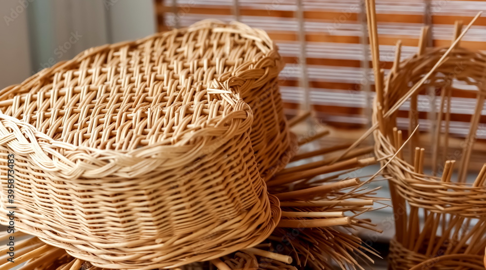 Elements of billets and products of weaving of vines closeup on the background of wooden blinds Elements of billets and products of weaving of vines closeup on the background of wooden blinds
