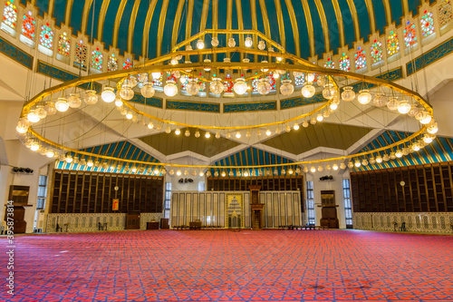 Interiors with big lamp on the roof of  in King Abdullah I Mosque in Amman, Jordan, built in 1989 by late King Hussein in honor of his father