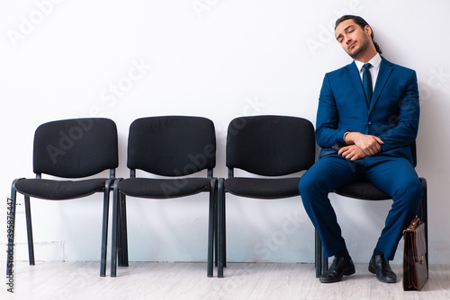 Young businessman waiting for an interview at hall