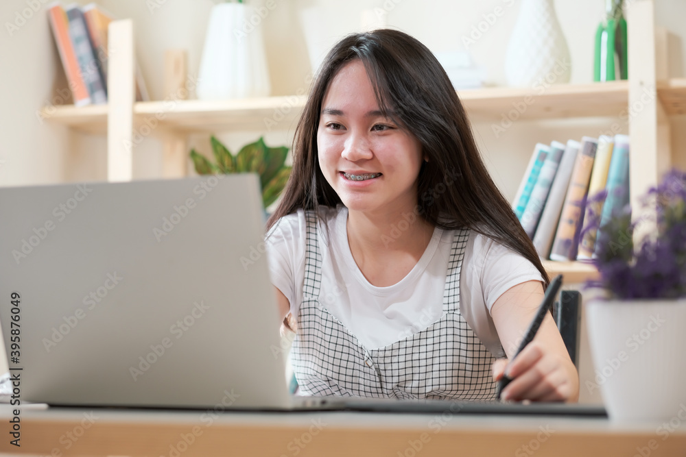 Young girl student studying at home library, using laptop computer, online school concepts,
Young girl student studying at home library, using laptop computer, online school concepts,