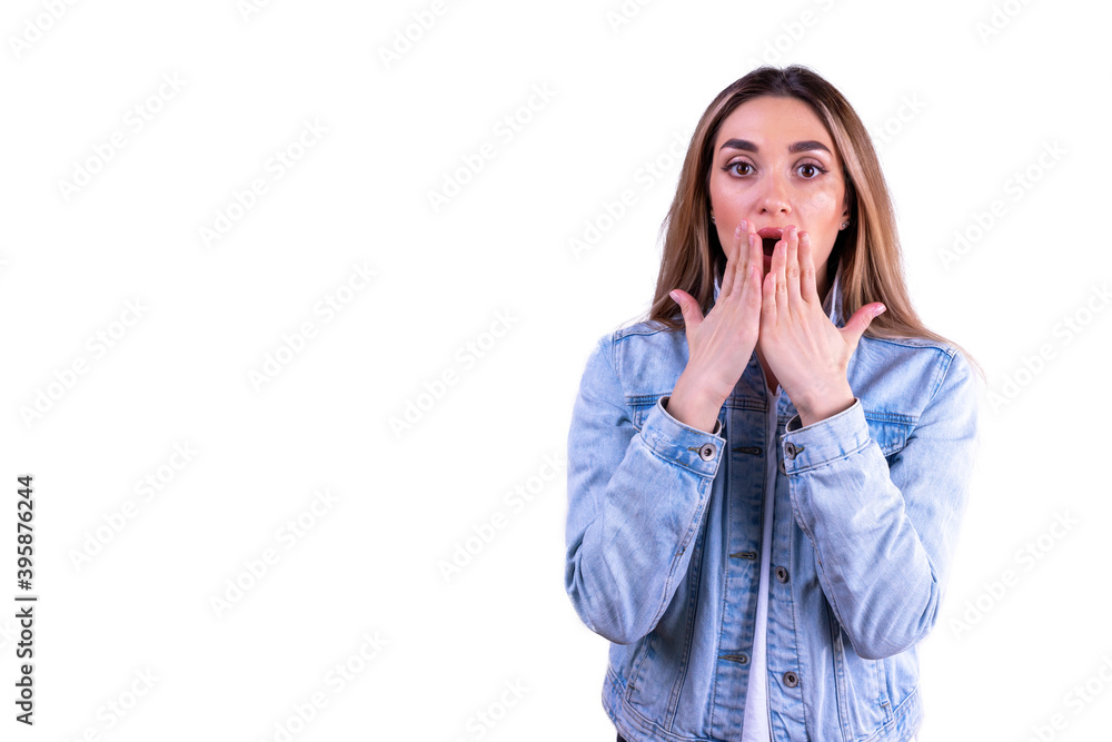 Surprised girl in a denim jacket on a white background Surprised girl in a denim jacket on a white background