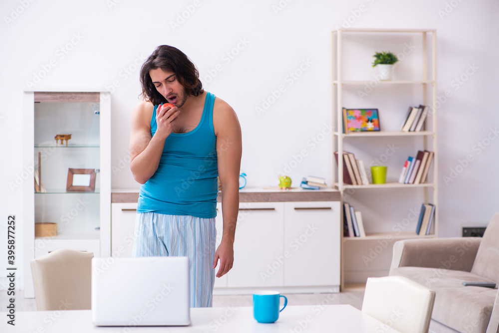 Young man waking up at home Young man waking up at home