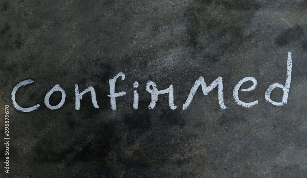 Fototapeta premium Confirmed Word Written on Blackboard with White Chalk