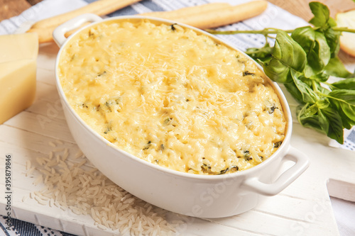 Baking dish with tasty rice casserole on table