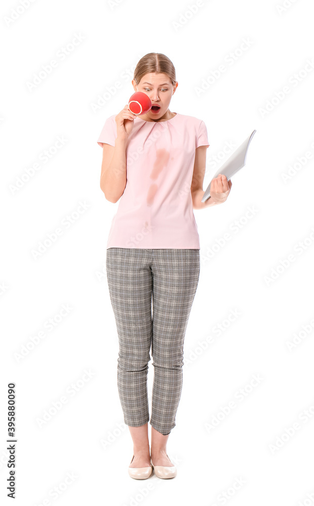 Stressed young woman with coffee stains on her shirt on white background Stressed young woman with coffee stains on her shirt on white background