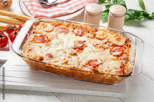 Baking dish with tasty rice casserole on table