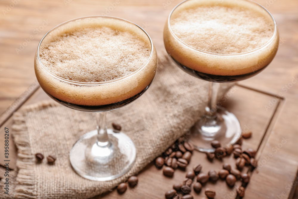 Two glasses of tasty espresso martini cocktail on wooden board Two glasses of tasty espresso martini cocktail on wooden board