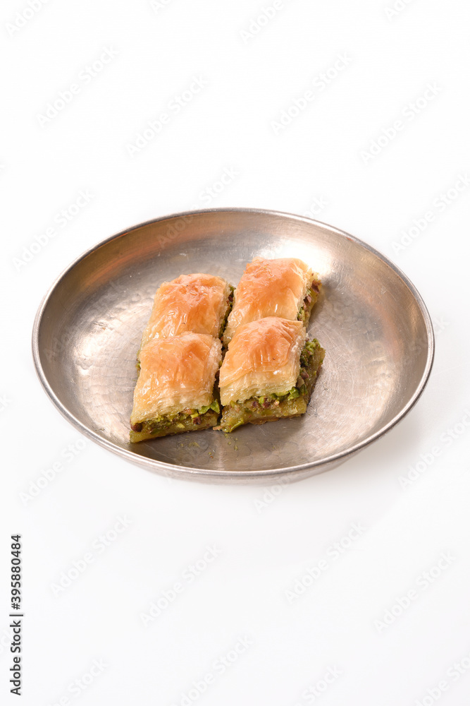 world famous baklava making in Gaziantep. Classic Baklava in metal plate on white background. world famous baklava making in Gaziantep. Classic Baklava in metal plate on white background.