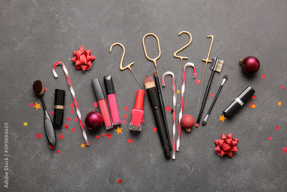 New Year composition with makeup cosmetics on dark background New Year composition with makeup cosmetics on dark background
