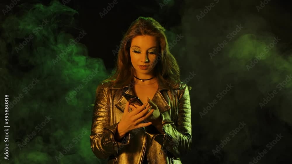 Portrait of young pretty woman is texting on her phone then shows smartphone with a green screen chroma key and showing thumbs up gesture. Close up. Slow motion. Portrait of young pretty woman is texting on her phone then shows smartphone with a green screen chroma key and showing thumbs up gesture. Close up. Slow motion.