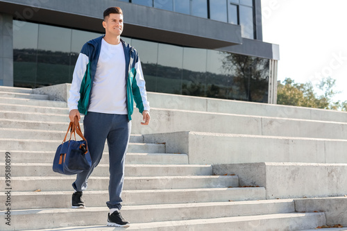 Sporty young man with bag o...