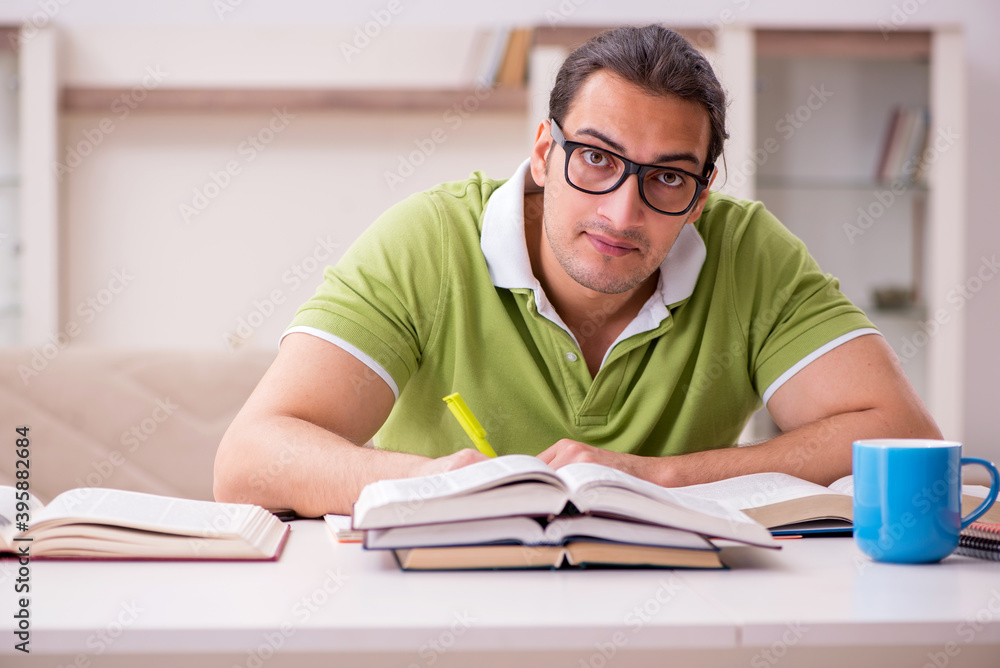 Young male student preparing for exams at home Young male student preparing for exams at home