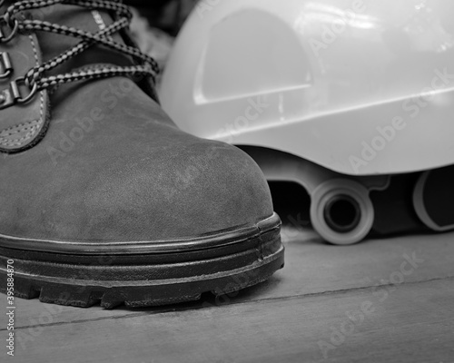 Isolated safety shoe or steel-toe boots used for construction purpose. photo