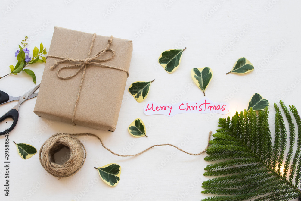 gift box with merry christmas message card handwriting for special in new year festival day arrangement on background white gift box with merry christmas message card handwriting for special in new year festival day arrangement on background white