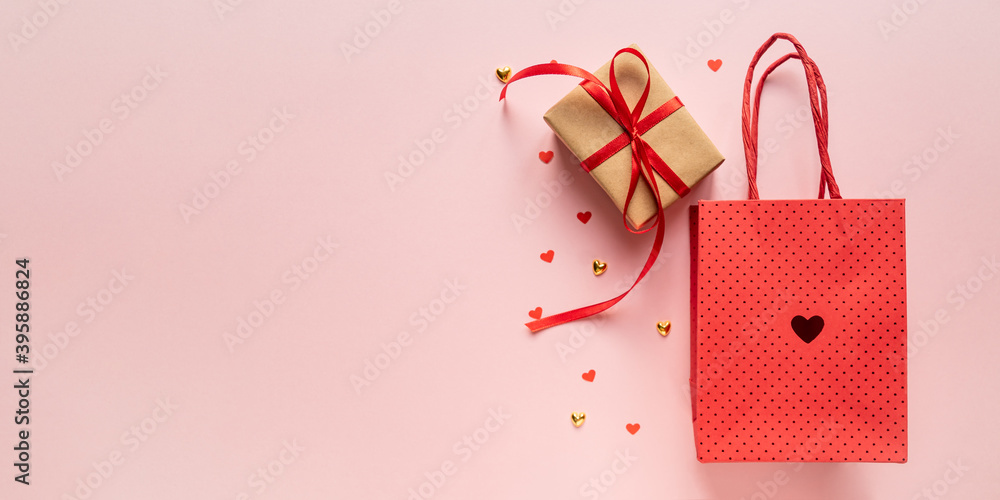 Paper craft Gift box with red ribbon bow, paper bag and red hearts. Festive concept for Valentine's day, Mother's day or birthday