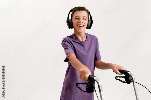 Quadro em tela Portrait of happy teenaged disabled boy with cerebral palsy in headphones smilin