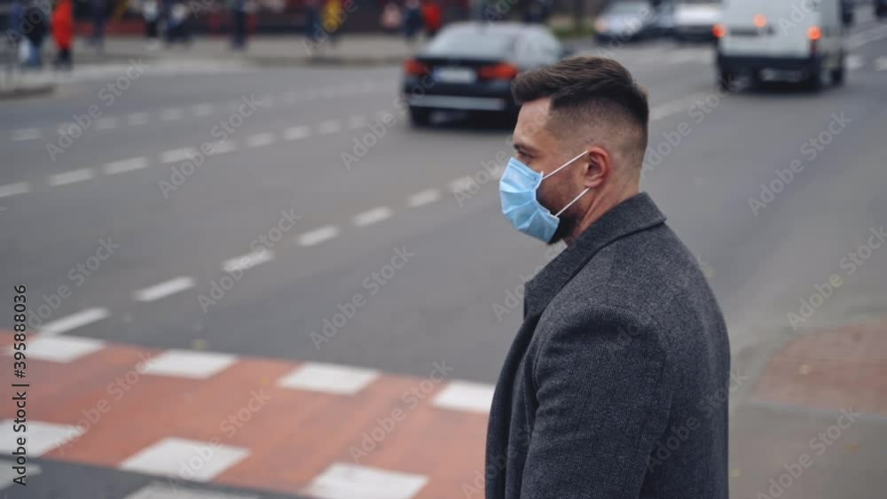 Guy wearing safety mask and walking on a road. Responsible behavior during world covid-19 pandemic. Guy wearing safety mask and walking on a road. Responsible behavior during world covid-19 pandemic.