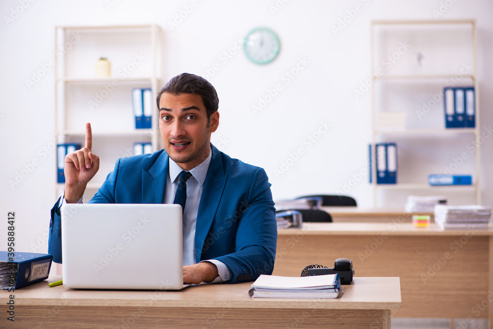 Young male employee and too many work in the office Young male employee and too many work in the office