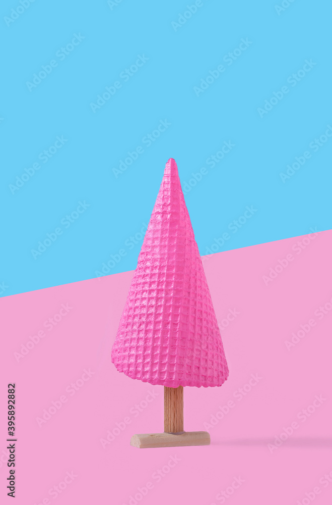 Creative concept with pink ice cream cone as Christmas tree. Christmas and holiday season concept Creative concept with pink ice cream cone as Christmas tree. Christmas and holiday season concept