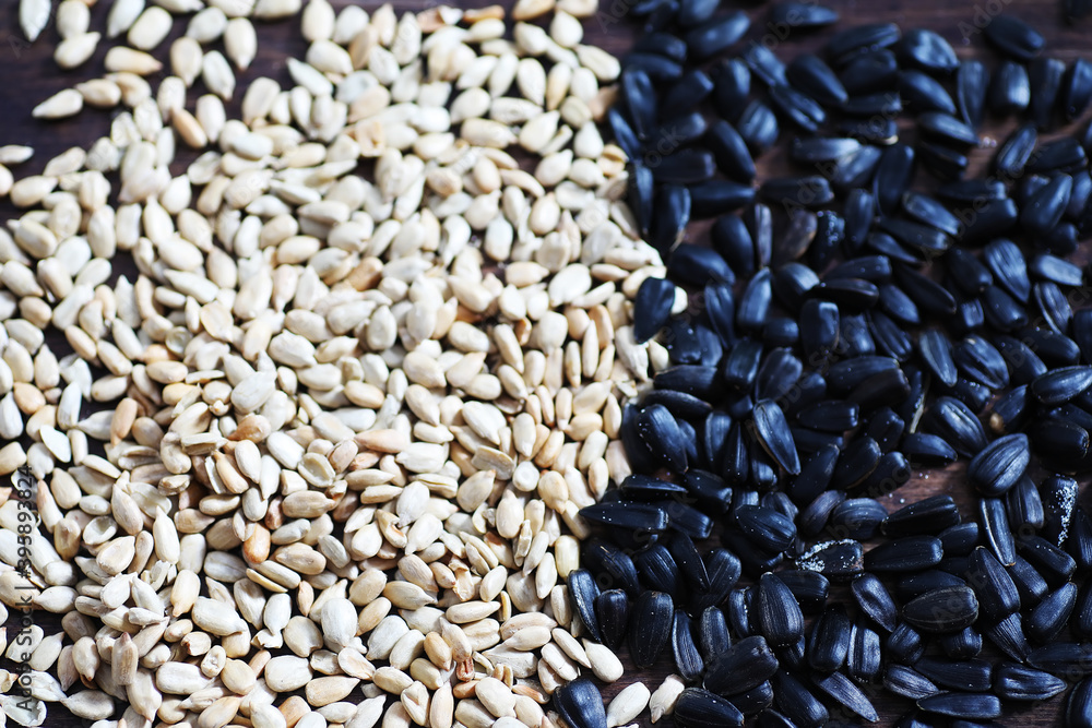 Obraz premium Sunflower seeds in a wooden spoon on a wooden rustic background.