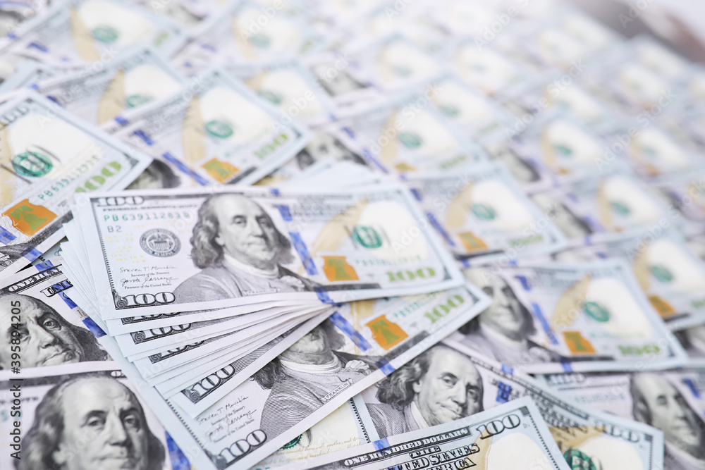 Group of money stack of 100 US dollars banknotes a lot of the background texture. Cash money in a large pile as a finance background. Group of money stack of 100 US dollars banknotes a lot of the background texture. Cash money in a large pile as a finance background.
