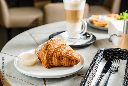 Photography croissant and cappuccino in the cafe
