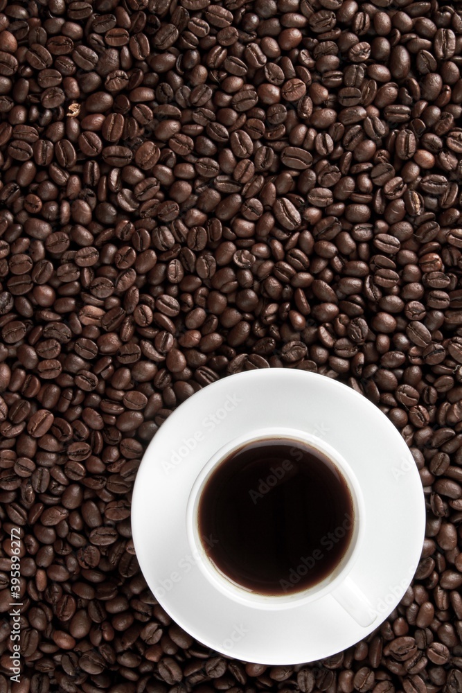 Cup of coffee surrounded by coffee beans Cup of coffee surrounded by coffee beans