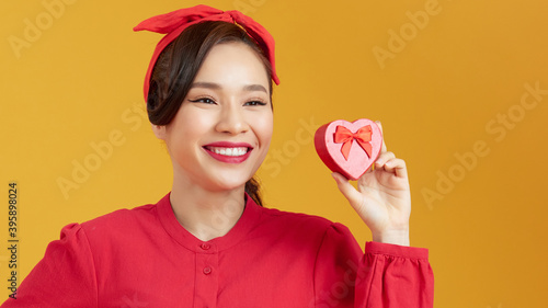 Woman holding heart-shaped box