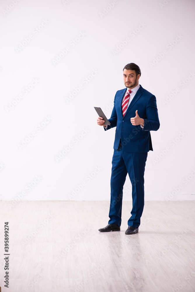Handsome male realtor working indoors Handsome male realtor working indoors