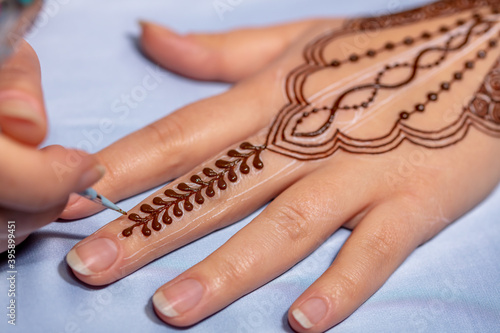 Mehndi draw on woman hand