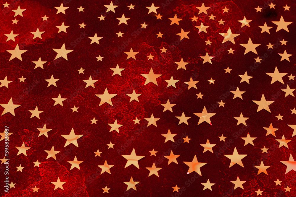 Bright Deep red Christmas stone background of stars colored in Fortuna Gold, golden starlets