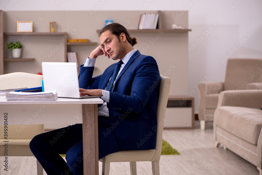 Young male employee working from home in pandemic concept Young male employee working from home in pandemic concept